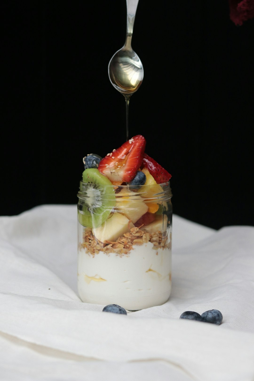 Curd and fruit parfait in a glass with kiwi and strawberry