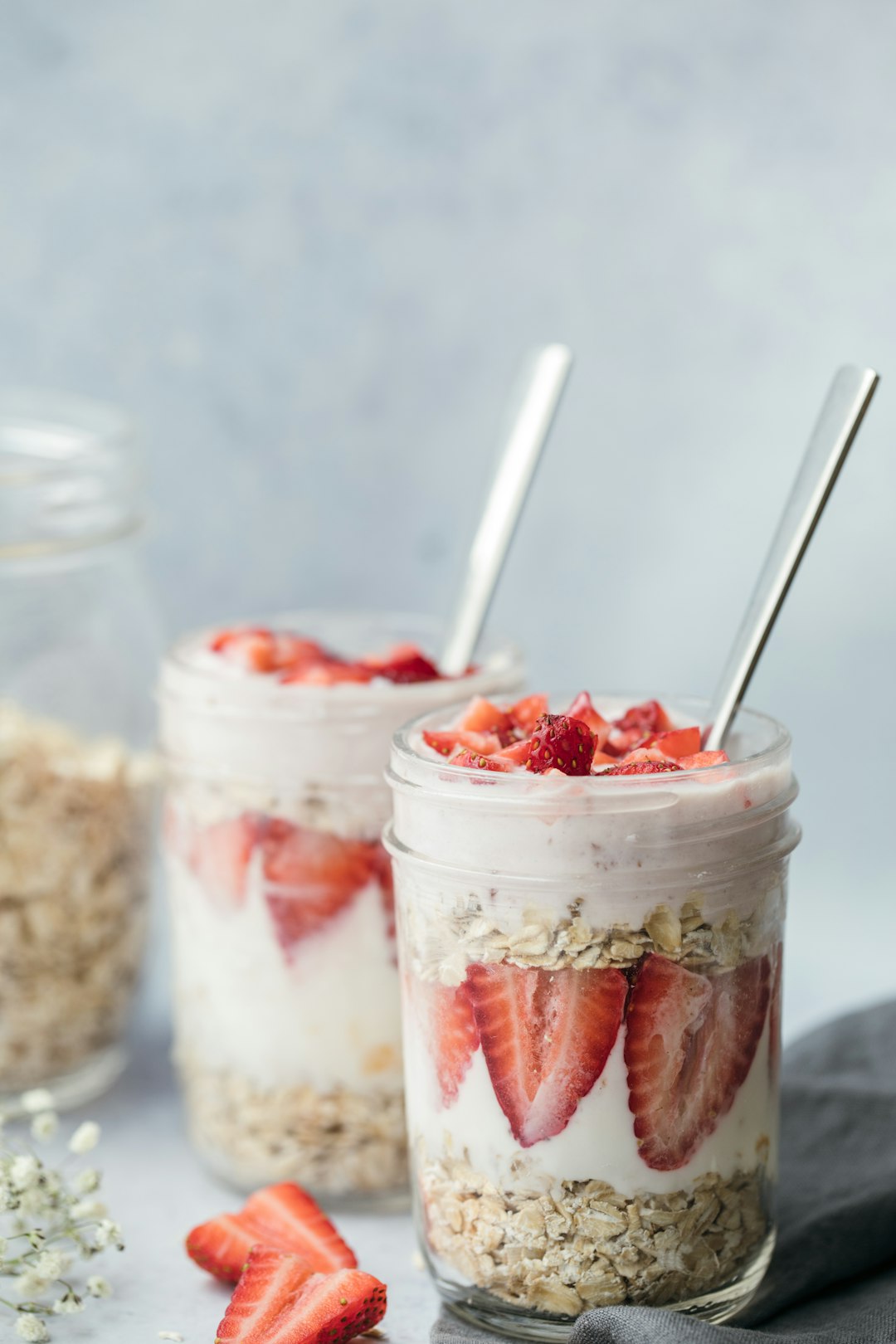 Overnight oats in glass jars topped with strawberries